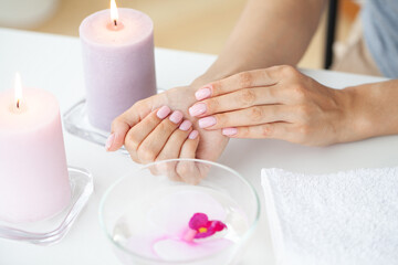 Obraz na płótnie Canvas Woman making manicure when resting at home