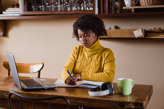 Black woman using laptop during smartworking. Lifestyle images.
