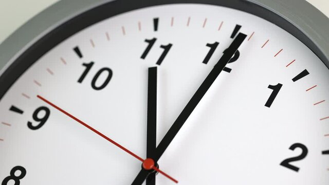 Large white wall clock Set the time for 11.00 o'clock. The red minute hand keeps running. Time lapse movie.
