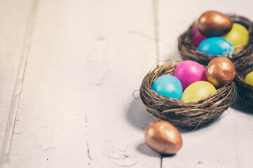 Easter eggs and chocolate eggs in nests