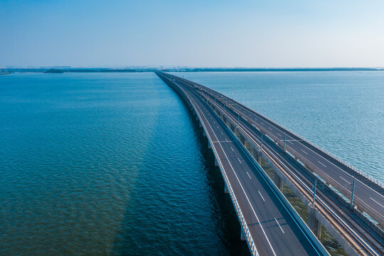 Aerial view of bridge road with cars over lake or sea