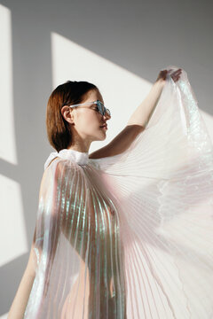 Fashionable young woman in plastic dress