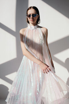 Fashionable young woman in color dress