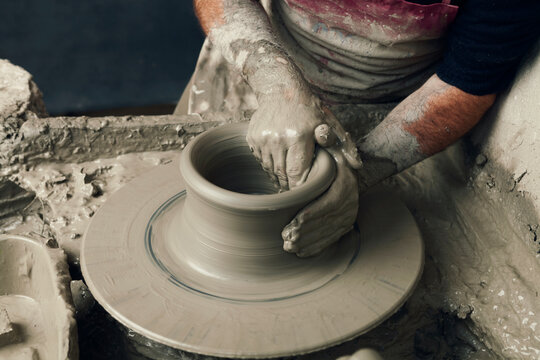 Ceramist, man's hands working on clay