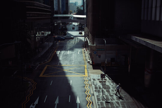 Man Walking In The City Holding A Closed Umbrella