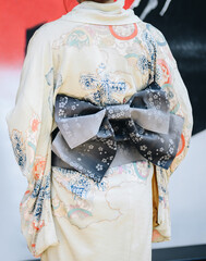 Rear view of Japanese woman wearing Yukata dress. A Japanese yukata is a lightweight form of...