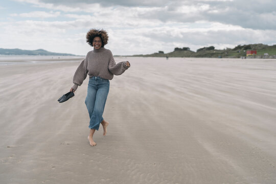 Happy Woman Walking Against the Wind