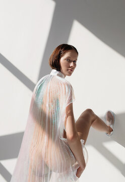 Slim woman in translucent garment