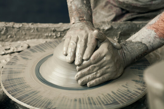 Ceramist, man's hands working on clay