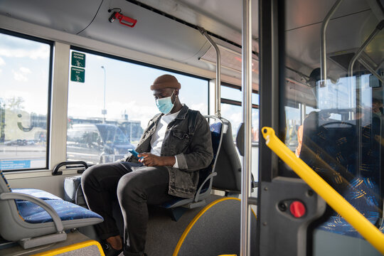 Man Traveling By Bus With Surgical Mask