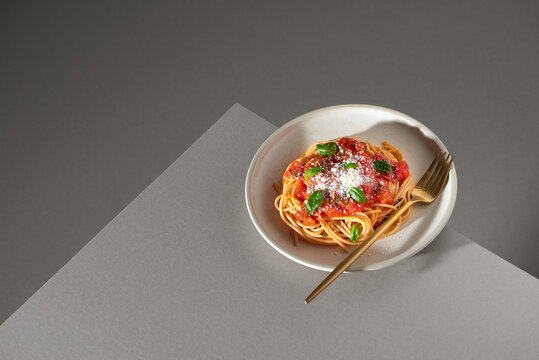 Tasty colorful appetizing cooked spaghetti italian pasta with tomato sauce bolognese and fresh basil.