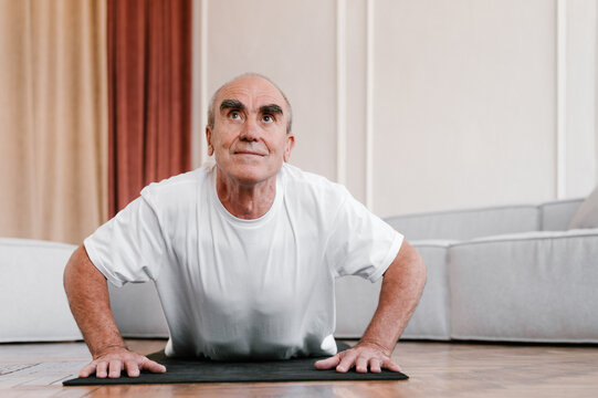Aged man doing exercises at home