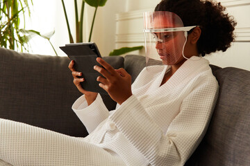 Relaxed woman watches movie on tablet