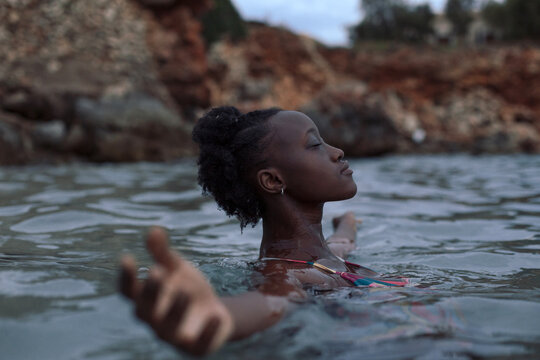 Black woman relaxing in the sea