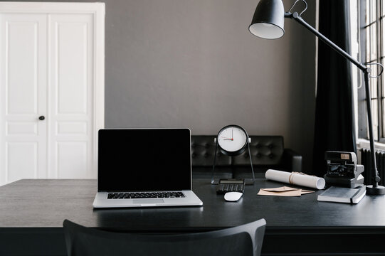 Workplace with laptop in minimalist style room