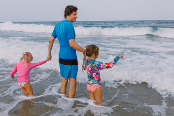 Kids on the beach with a dad