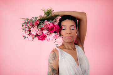 portrait of a beautiful Black woman wearing wedding dress with pink flowers