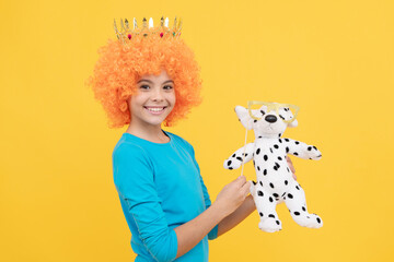 lets play. girls birthday party. happy funny kid in curly wig and crown. imagine herself a queen
