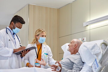 Doctors examining a senior patient