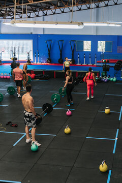 Group of athletes exercising with kettlebells