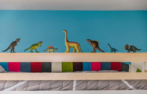 Toy Dinosaur Figures in Bedroom of Child on bed