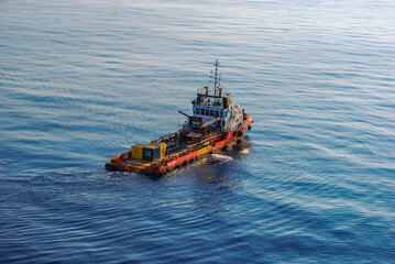 Anchor handling tug utility boat at open sea and at offshore oil and gas field.