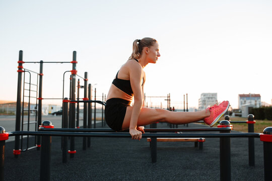 Fit female athlete exercising on sports ground