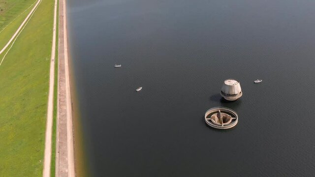 Bewl Water Reservoir Draw Off Tower And Overflow Tower Sunny Day. Aerial flyover. Kent,England.