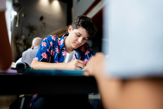 Student writing in library