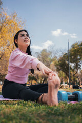 young woman doing stretching outdoors