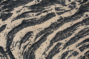 Lava flow partially covered by sand