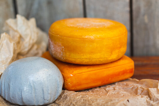 various types of cheese on a rustic wooden table