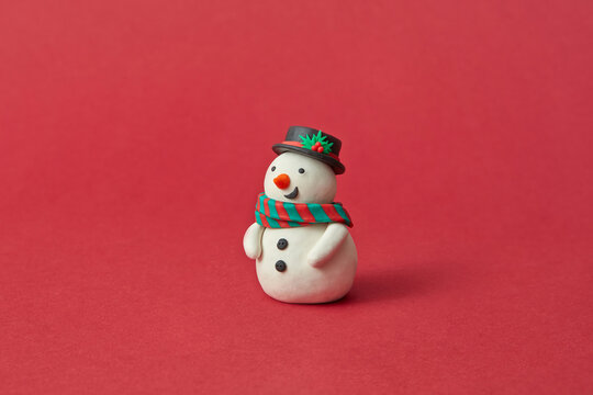 Handmade figure of Snowman from modeling clay.