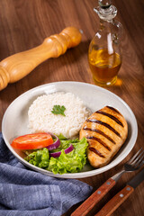 Grilled chicken with salad and rice.