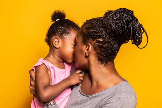 Black mother and son looking at camera