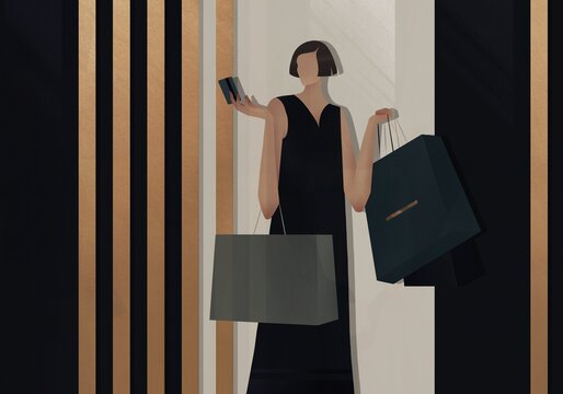 woman with purchases holds credit card in hand