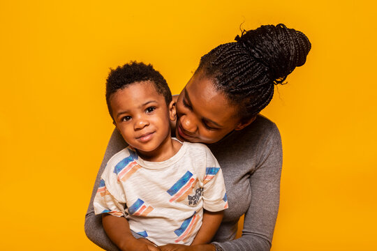 Black mother and son looking at camera