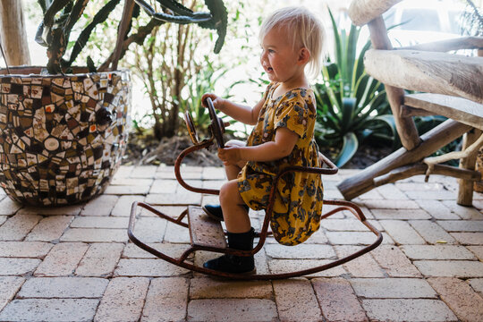 Little Girl On Rocking Horse