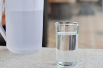 a glass of water on a wooden table in a cafe
