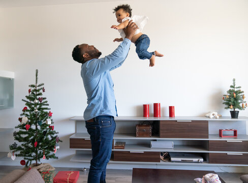 Father Playing With Child At Home