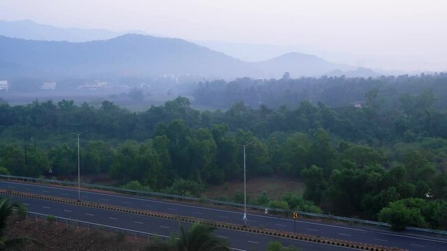 Aerial View Of Highway In Netravali, South Goa, India With Cotigao Wildlife Sanctuary In Lush Misty Background. wide shot