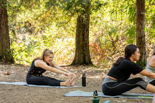Women Reach For a Stretch at Yoga Class.