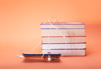 book and headphones. concept of audiobooks and education