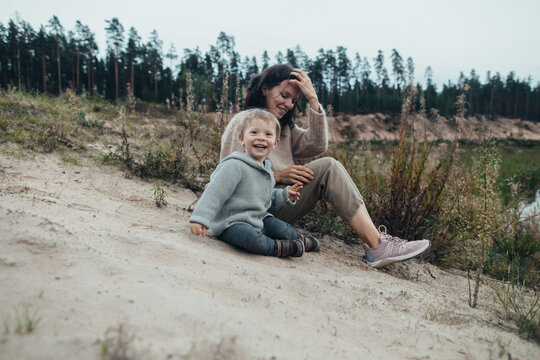 Woman and little son on the sand slope