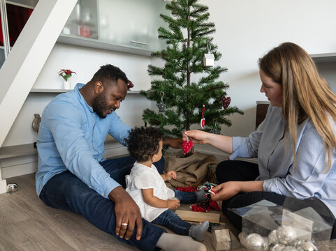Mixed Race Family Decorating Christmas Tree
