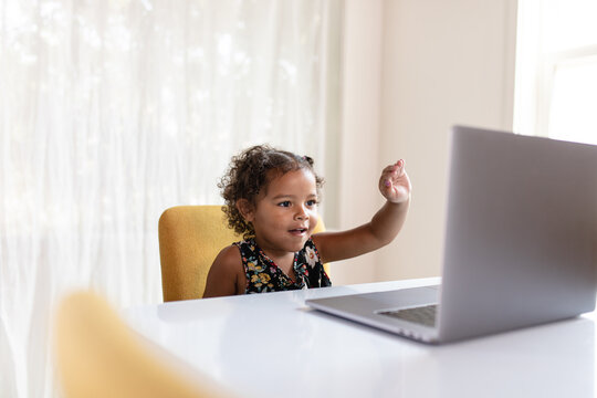 Young Girl Waves at Classmates