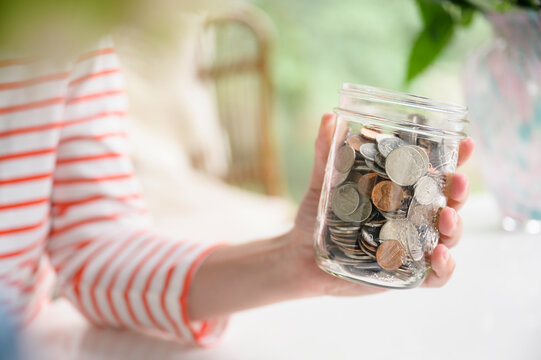 Holding a Jar of Coins