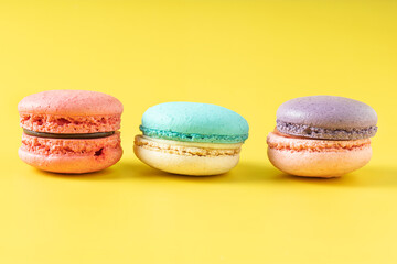 Close up french macaron on yellow background.