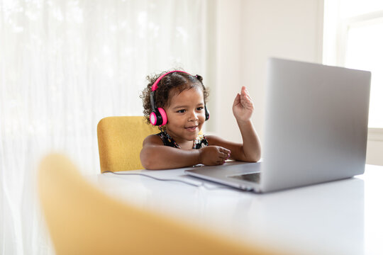 Child Waves at Classmates During Virtual Learning