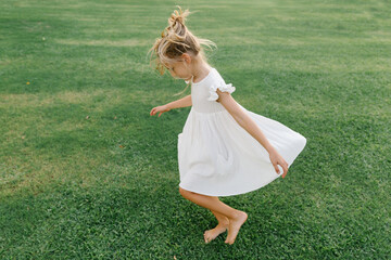Girl twirling on the lawn